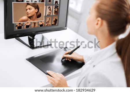 photography, office and magazine concept - female retoucher with drawing tablet and computer working at home or office
