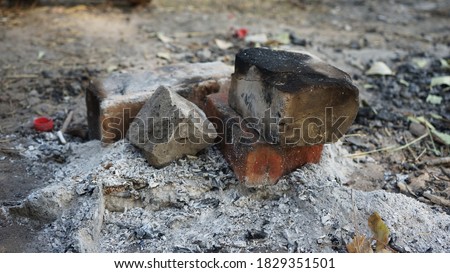  
extinguished coals after a fire on the ground                              