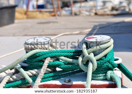 Marine rope on mooring bollard in port of Podgora, Croatia. Horizontal photo