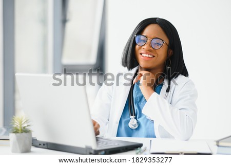 Portrait of african american happy smiling young doctor in headset consulting patient over the phone. Health care call center online concept Royalty-Free Stock Photo #1829353277