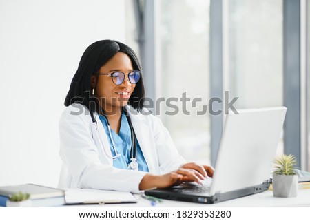 Portrait of african american happy smiling young doctor in headset consulting patient over the phone. Health care call center online concept Royalty-Free Stock Photo #1829353280