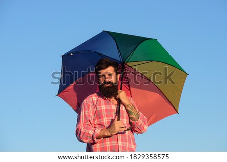 Shoulder portrait of gay man, homosexual male holding rainbow umbrella, colored in rainbow colors. LGBT movement, gay pride banner template