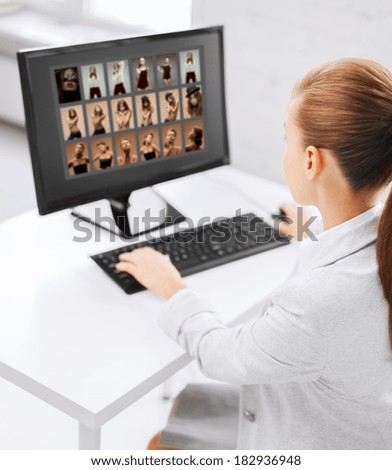 photography, office and magazine concept - editor choosing pictures from computer monitor