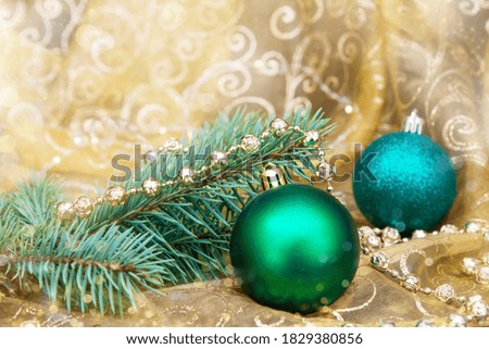 Christmas picture on a gold background spruce branch with green balls