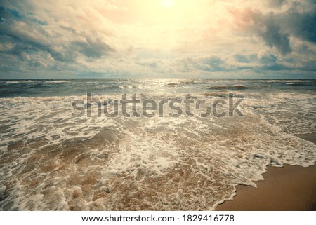 Seascape. Seashore at sunset.  Landscape with ocean and bright cloudy sky