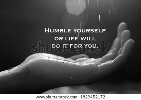 Inspirational quote - Humble yourself or life will do it for you. With open arm hand receiving the light on black and white abstract art background.  Royalty-Free Stock Photo #1829452172