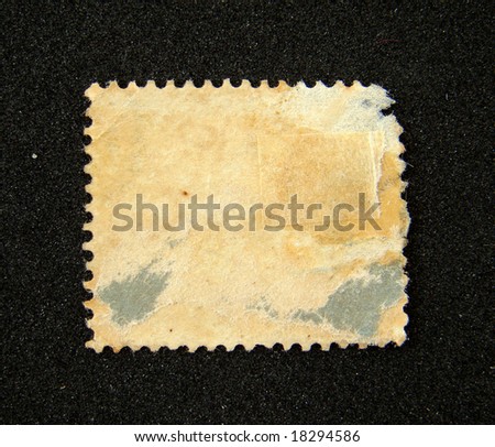 Blank and worn postage stamp on black background