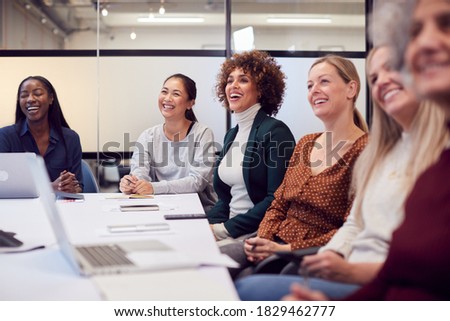Line Of Businesswomen In Modern Office Listening To Presentation By Colleague Royalty-Free Stock Photo #1829462777