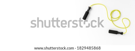 Overhead shot of jumping rope on white background. Gym concept. Banner Royalty-Free Stock Photo #1829485868