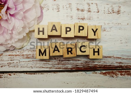 Happy March alphabet letters on wooden background