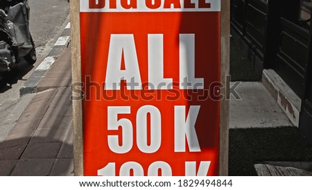 White text on a red sign with the inscription big sale