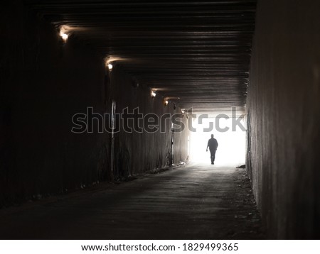 The light at the end of the tunnel with a human silhouette