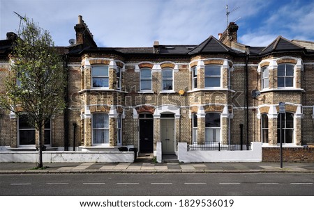 A terrace of Victorian period houses in west London, UK. Royalty-Free Stock Photo #1829536019