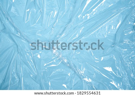 Clear plastic texture with blue color. Nylon polythene wrap. Plastic free lifestyle, ecology pollution 