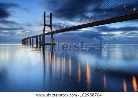 Lisbon is an amazing tourist destination because their urban landscapes, by its light, its monuments. The Vasco da Gama Bridge crosses the Tagus River, and is one of the longest bridges in the world. Royalty-Free Stock Photo #182958764