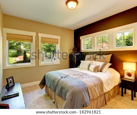 Carpet bedroom with contrast color wall. Beautiful bedding.