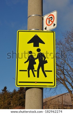 School children crossing ahead sign