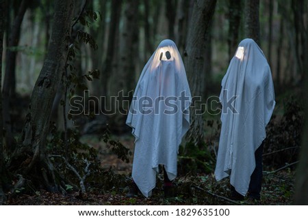 ghost in a dark forest Halloween background 