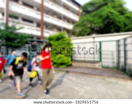 Elementary school students line up to go home after school .backdrop and design element use. Defocused background with bokeh light.