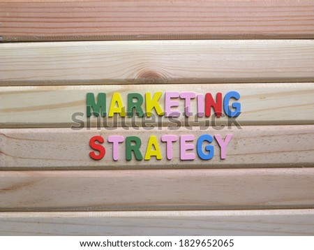Words Marketing strategy on wood background