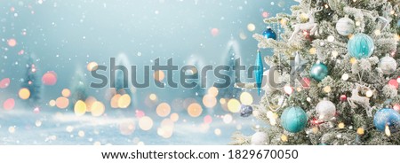 Christmas Tree with Decoration On A Winter Background With Bright Lights And Snow