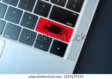 Transport delivery key with truck icon on laptop keyboard. Online shopping / ecommerce and retail sale concept : delivery van for customers ordering things from retailers websites using internet