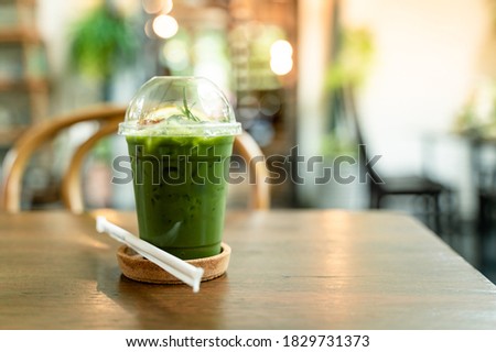 Picture of green tea drinks in transparent plastic glasses on the table Cafe shop bokeh background