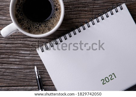 Happy new year 2021 concept: Close up calendar and coffee on desktop 