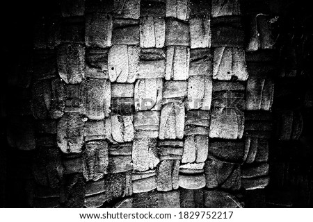 Abstract grunge matrass texture made from weaved fabric. Use as a background or wallpaper. Space for text. Black and white, so contrast and grainy