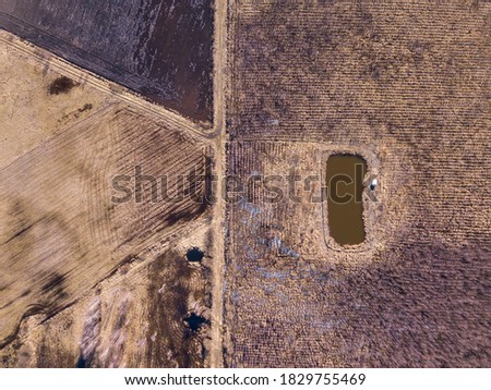 Early spring aerial abstract field landscape. Top down aerial.