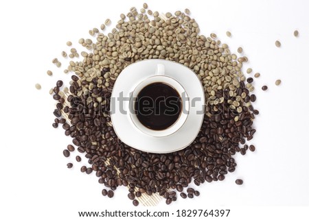 Black coffee is served in a glass cup, which is placed on a bamboo plate and sprinkled with neatly arranged coffee beans.