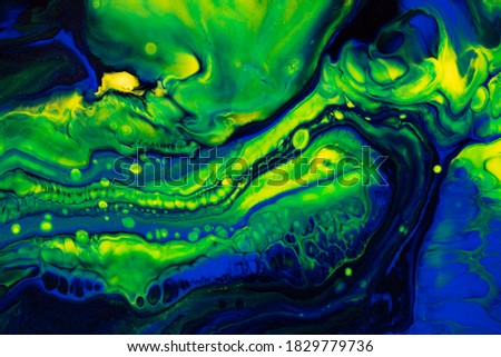 Fluid art texture. Backdrop with abstract mixing paint effect. Liquid acrylic artwork with flows and splashes. Mixed paints for baner or wallpaper. Green, blue and yellow overflowing colors.