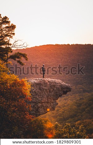 A hiker stands out on Whitaker Point at sunrise Royalty-Free Stock Photo #1829809301