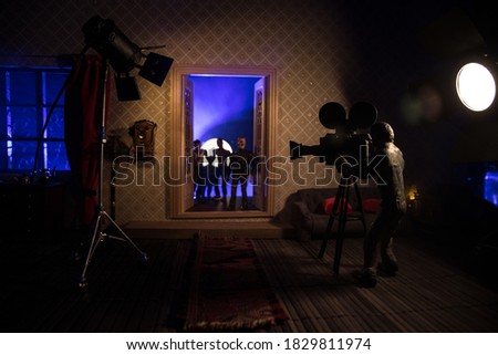 A realistic dollhouse living room with furniture, door and window at night. Horror movie backstage concept. Selective focus.