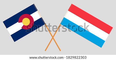 Crossed flags of The State of Colorado and Luxembourg