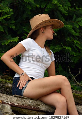 Sitting girl in the summer in a hat