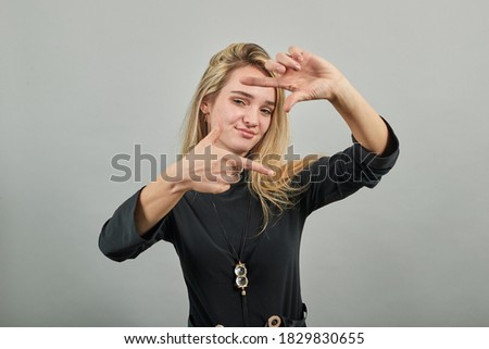 Hands making photo frame, fingers framing distance, photography sign made by human arm, framework formed, feeling happy, friendly and positive, smiling, portrait.