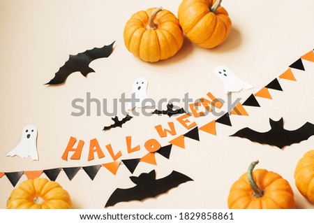 halloween and decoration concept - black paper bats and paper cards made of cardboard flying over white background
