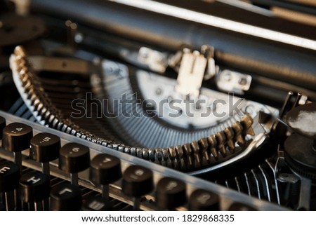 Close-up of letters of an old classic retro typewriter. Background from parts of typewriter with an engraving for printing text. Type of Soviet-era typewriter. Copy space