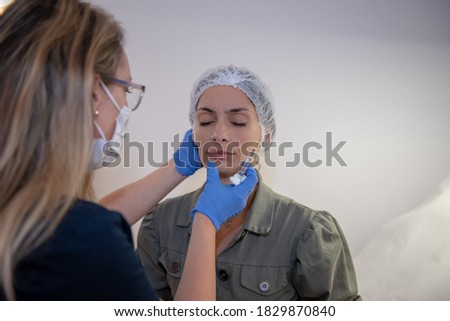 Doctor dermatologist, preparing patient for procedure - beauty correction holding syringe and needle in hand. Skin care and beauty correction treatment concept 