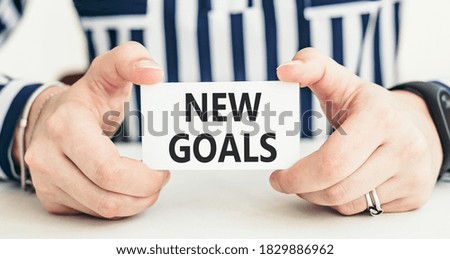 Handwriting text NEW GOALS on card, business concept