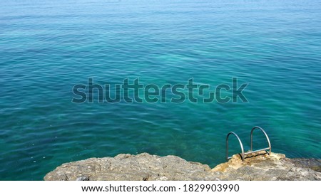 Bathing area by the turquoise sea with handles Royalty-Free Stock Photo #1829903990