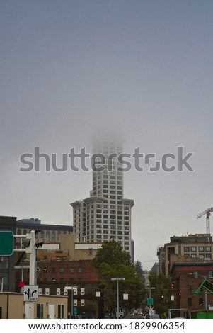 VIEW OF PIONEER SQUARE IN SEATTLE WASHINGTON FROM THE WATER FRONT  WITH THE SKYLINE IN FOG