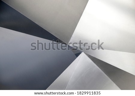 Angular metal panels. Steel sheets resembling abstract modern architecture exterior or interior detail. Industrial background in hi-tech style. Polygonal geometric pattern of triangles.