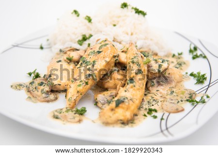 Creamy Herb Mushroom Chicken with Steamed Rice on a white plate