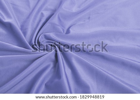 Very Peri blue Knitted elastic fabric, weaving of threads texture, curl crumpled fold. For underwear, sports clothes and swimwear. Space for text. Royalty-Free Stock Photo #1829948819