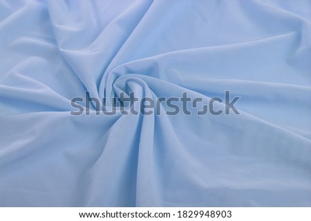 blue Knitted elastic fabric, weaving of threads texture, curl crumpled fold. For underwear, sports clothes and swimwear. Space for text. Royalty-Free Stock Photo #1829948903
