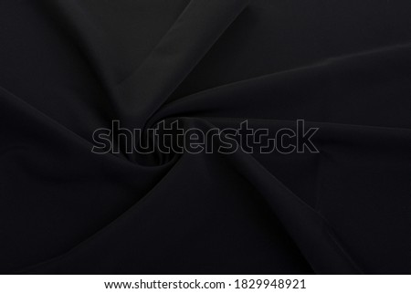 black Knitted elastic fabric, weaving of threads texture, curl crumpled fold. For underwear, sports clothes and swimwear. Space for text. Royalty-Free Stock Photo #1829948921
