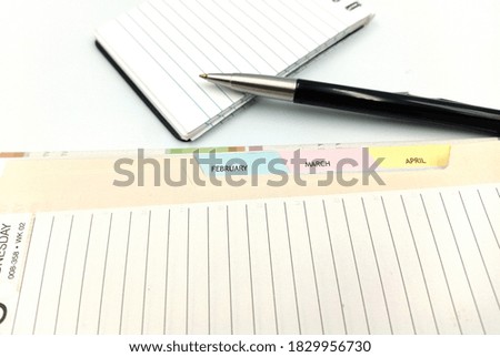 Notice diary with the pen on the isolated white background