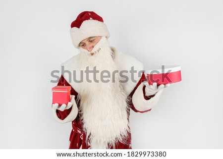 Holidays and Christmas concepts. Santa Claus holds gifts in his hands. Isolated on white